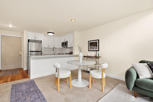 dining area featuring baseboards and recessed lighting