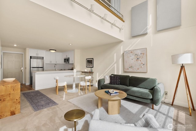 living room featuring baseboards and recessed lighting