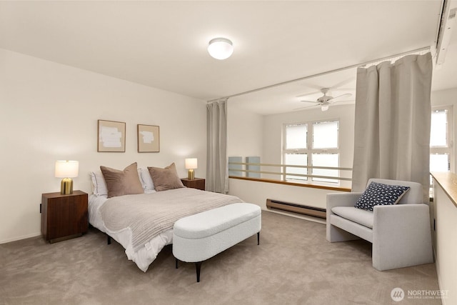 bedroom featuring multiple windows, baseboard heating, and light carpet