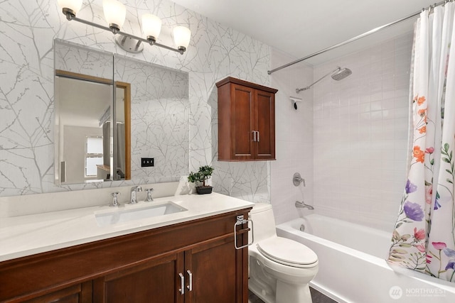 bathroom featuring vanity, shower / bath combination with curtain, toilet, and wallpapered walls