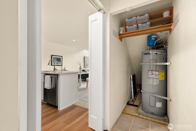 utilities featuring water heater and a sink