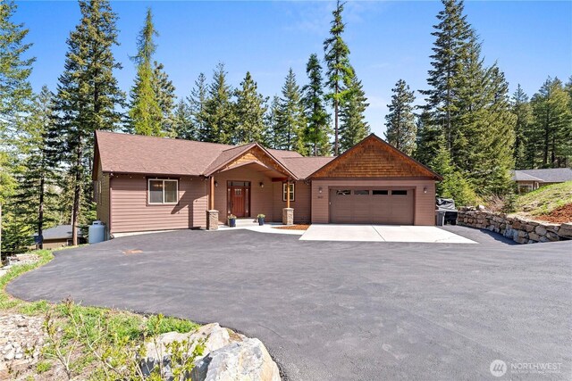 view of front of home with an attached garage and aphalt driveway