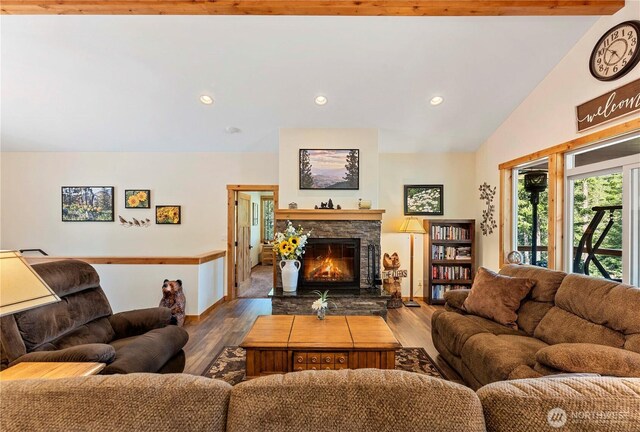 living room featuring recessed lighting, wood finished floors, lofted ceiling, and a fireplace