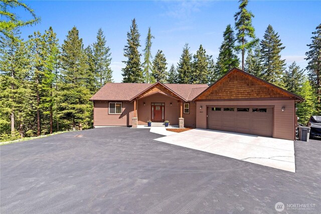 view of front of home featuring an attached garage and aphalt driveway