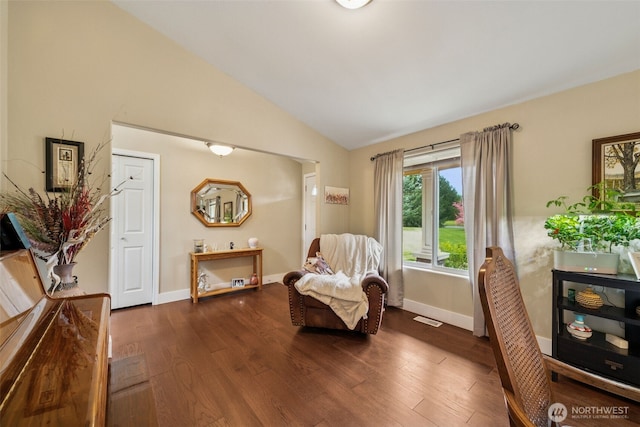 living area featuring dark wood-style flooring, baseboards, vaulted ceiling, and visible vents