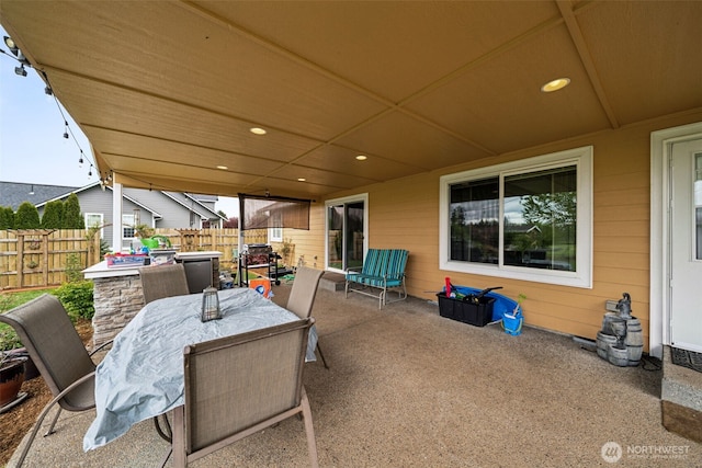 view of patio with fence and outdoor dining space
