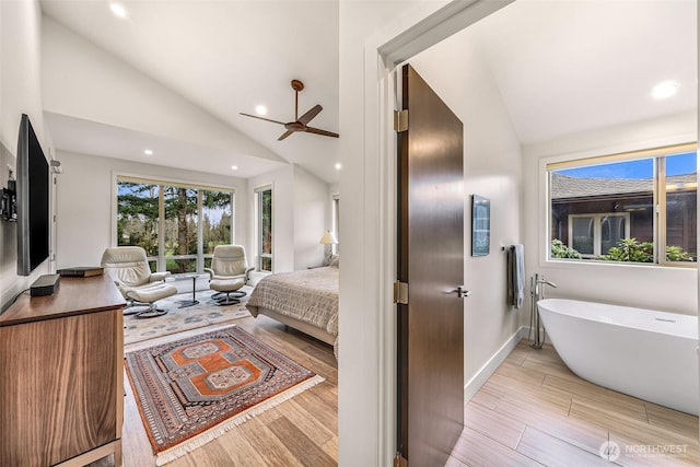 bedroom with recessed lighting, vaulted ceiling, and light wood finished floors