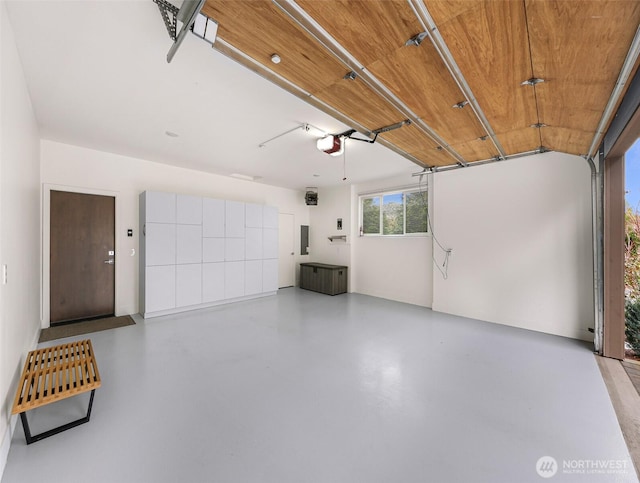 garage featuring a garage door opener and electric panel