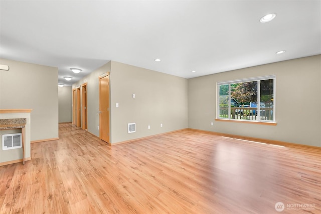 1321 Wilson Ave, Blaine, WA 98230 - unfurnished living room featuring light wood-type flooring, recessed lighting, and baseboards