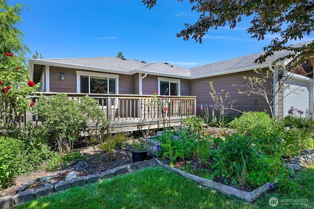 1321 Wilson Ave, Blaine, WA 98230 - rear view of property with a wooden deck, a vegetable garden, and roof with shingles