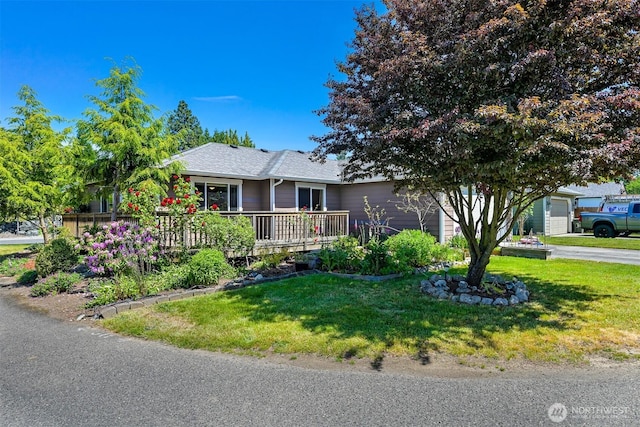 1321 Wilson Ave, Blaine, WA 98230 - ranch-style home with a front lawn, an attached garage, roof with shingles, and a deck