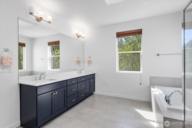 1616 96th Dr SE, Lake Stevens, WA 98258 - bathroom with healthy amount of natural light, double vanity, baseboards, and a bathtub