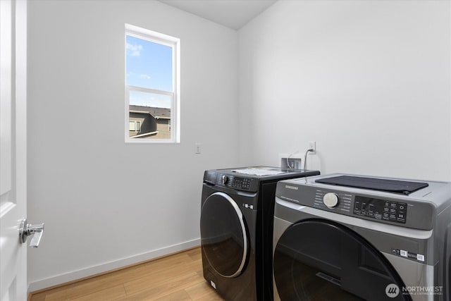 1616 96th Dr SE, Lake Stevens, WA 98258 - clothes washing area with washer and clothes dryer, light wood-style flooring, and baseboards