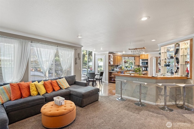 living area featuring baseboards, light carpet, crown molding, and recessed lighting
