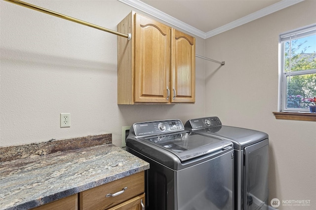 clothes washing area with ornamental molding, cabinet space, and independent washer and dryer