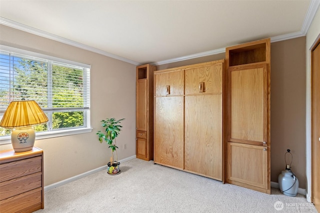 bedroom with baseboards, a closet, light colored carpet, and crown molding