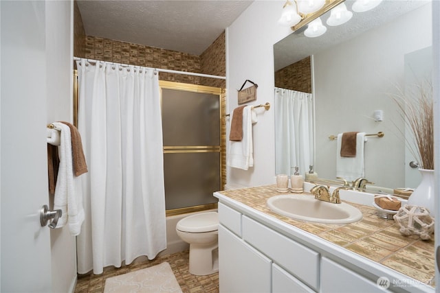 bathroom with vanity, toilet, a textured ceiling, and shower / tub combo