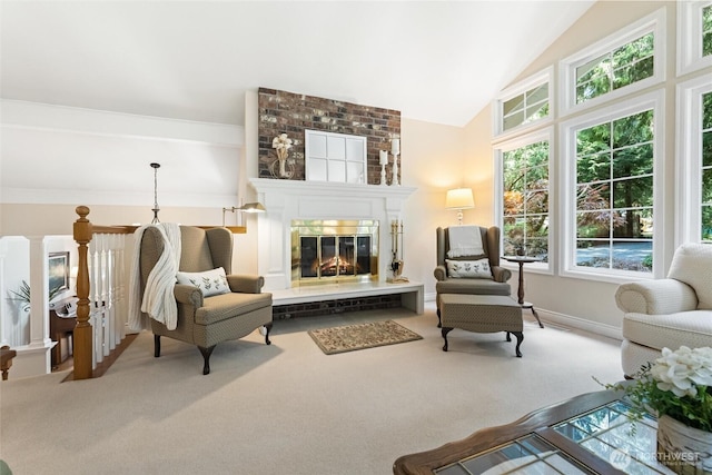 sitting room with carpet flooring, a fireplace, and vaulted ceiling