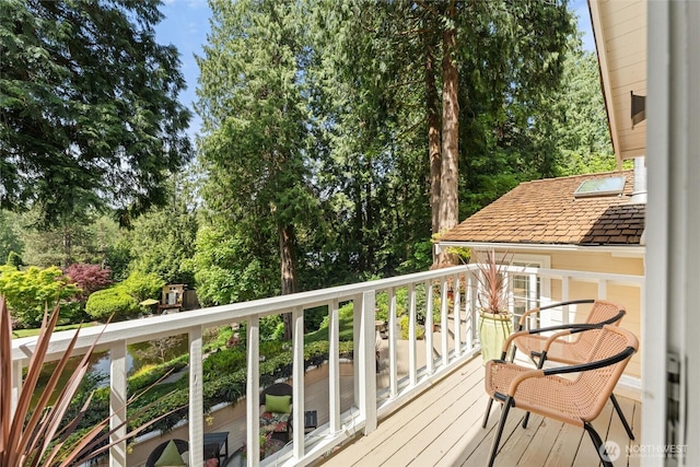 balcony featuring view of scattered trees