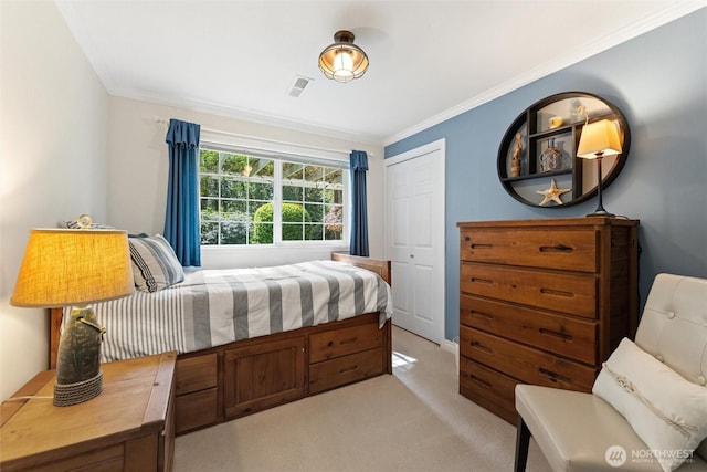 bedroom featuring light carpet, ornamental molding, and a closet