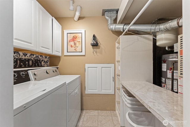 laundry room featuring cabinet space, washer and clothes dryer, and water heater