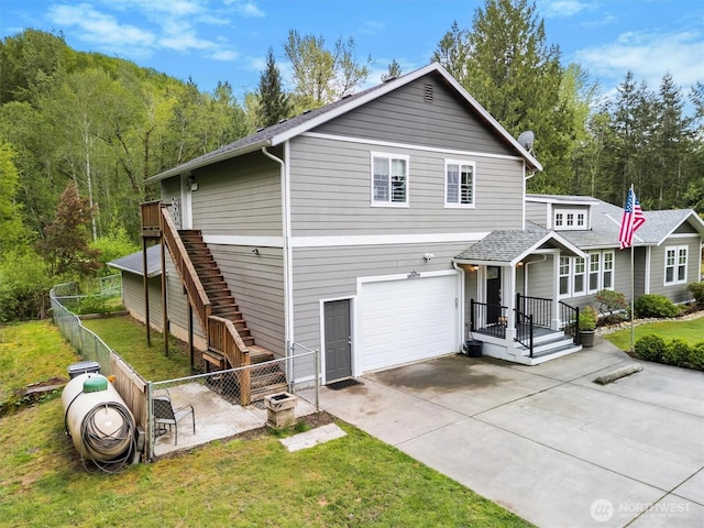 21702 Little Mountain Rd, Mount Vernon, WA 98274 - view of front facade featuring concrete driveway, fence, a front lawn, and a garage