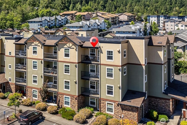 view of property with a wooded view