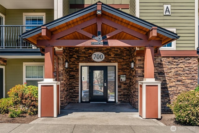 property entrance featuring stone siding