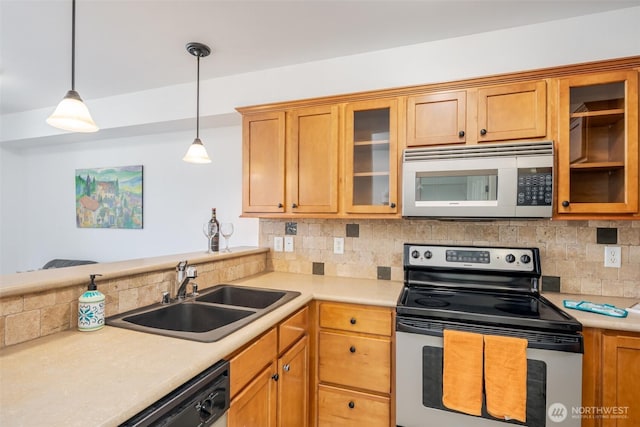 kitchen featuring electric range, white microwave, a sink, decorative backsplash, and light countertops