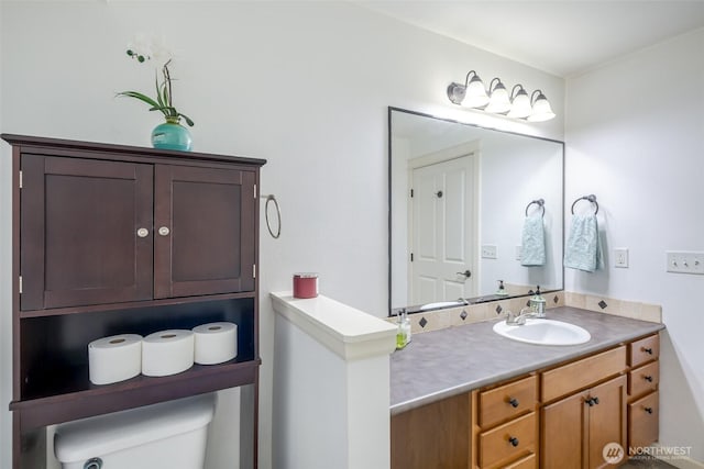 bathroom featuring toilet and vanity