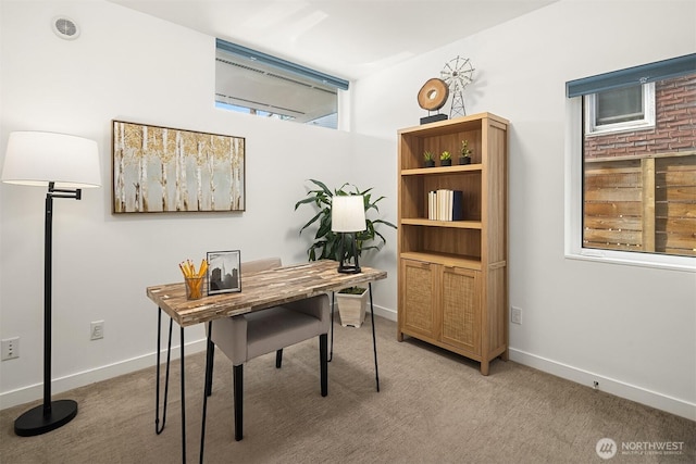 home office with light colored carpet and baseboards