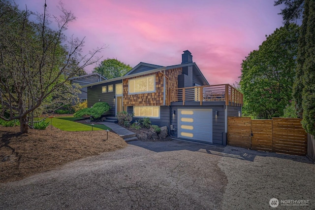 10201 NE 198th St, Bothell, WA 98011 - view of front of home with a chimney, fence, a balcony, aphalt driveway, and an attached garage