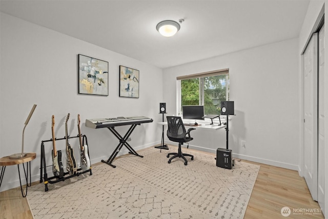 office space featuring baseboards and wood finished floors