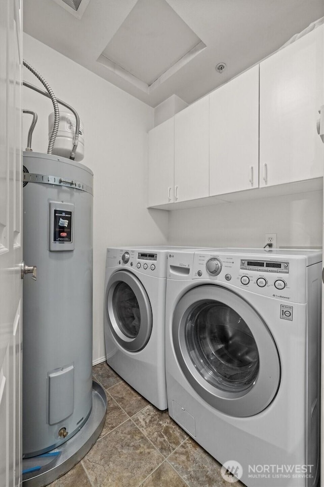laundry area featuring water heater, cabinet space, and washer and clothes dryer