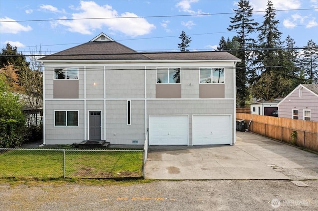 view of front of home featuring roof with shingles, a front lawn, driveway, a garage, and fence private yard