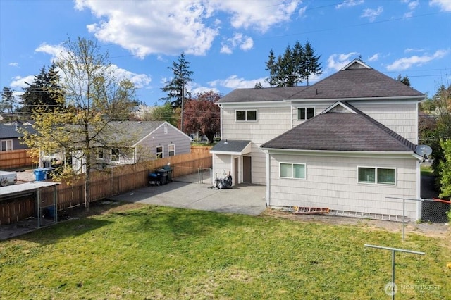 rear view of property with a patio area, roof with shingles, a fenced backyard, and a lawn