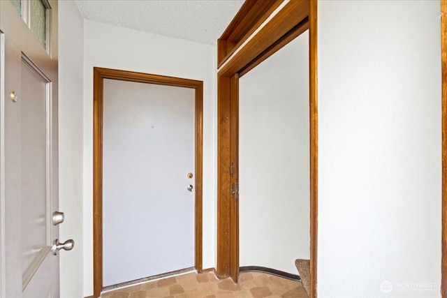 entryway with a textured ceiling