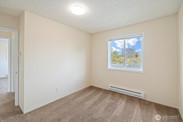 carpeted spare room featuring a baseboard radiator and a textured ceiling
