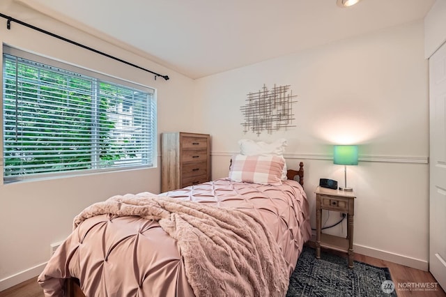 bedroom featuring baseboards and wood finished floors
