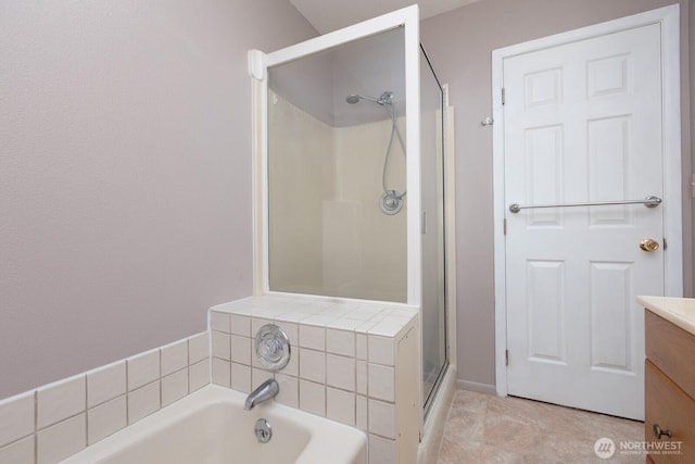 bathroom with vanity, a garden tub, and a stall shower
