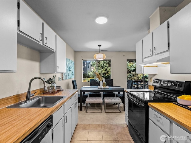 14148 74th Pl NE Unit 12C, Kirkland, WA 98034 - kitchen with hanging light fixtures, light tile patterned floors, electric range, under cabinet range hood, and a sink