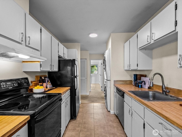 14148 74th Pl NE Unit 12C, Kirkland, WA 98034 - kitchen with stacked washer and dryer, under cabinet range hood, black / electric stove, dishwasher, and a sink