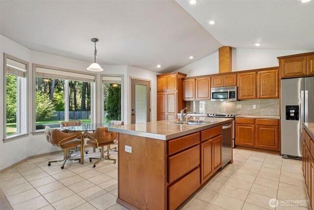 kitchen featuring tasteful backsplash, brown cabinets, a sink, stainless steel appliances, and light tile patterned flooring