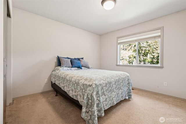 carpeted bedroom featuring baseboards
