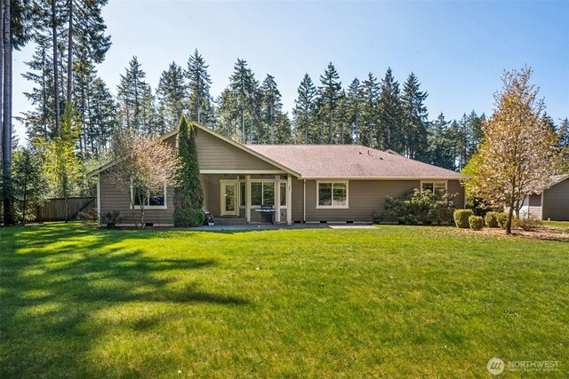 back of property with fence, a patio, a lawn, and crawl space