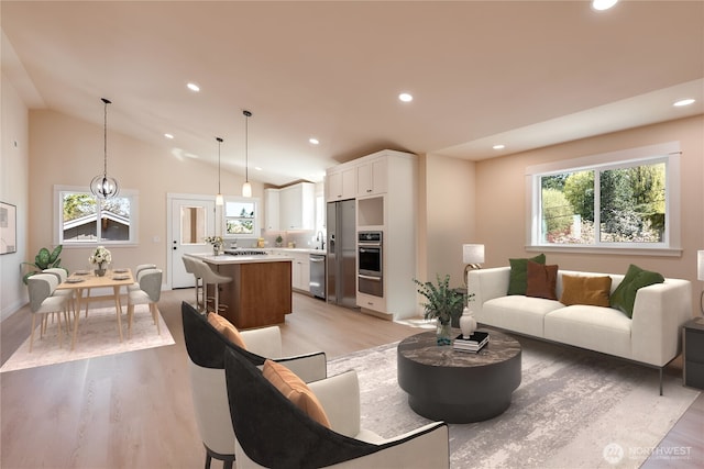 living area with plenty of natural light, light wood finished floors, recessed lighting, and vaulted ceiling