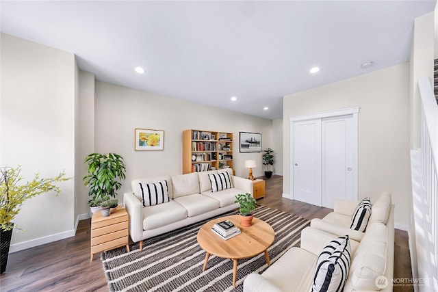 living room with dark wood-style flooring, baseboards, and recessed lighting