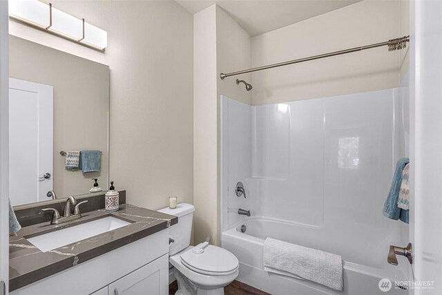 full bathroom featuring shower / bathtub combination, toilet, and vanity