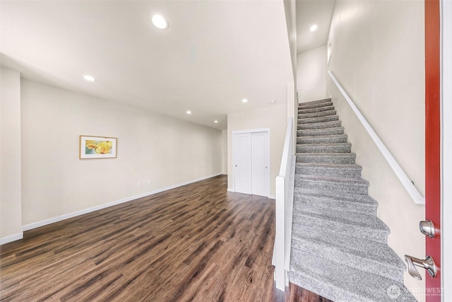 staircase with recessed lighting, baseboards, and wood finished floors