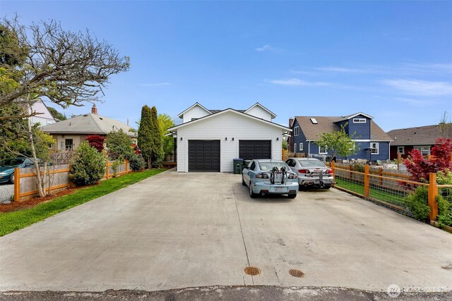 ranch-style house with fence, a residential view, driveway, and a garage